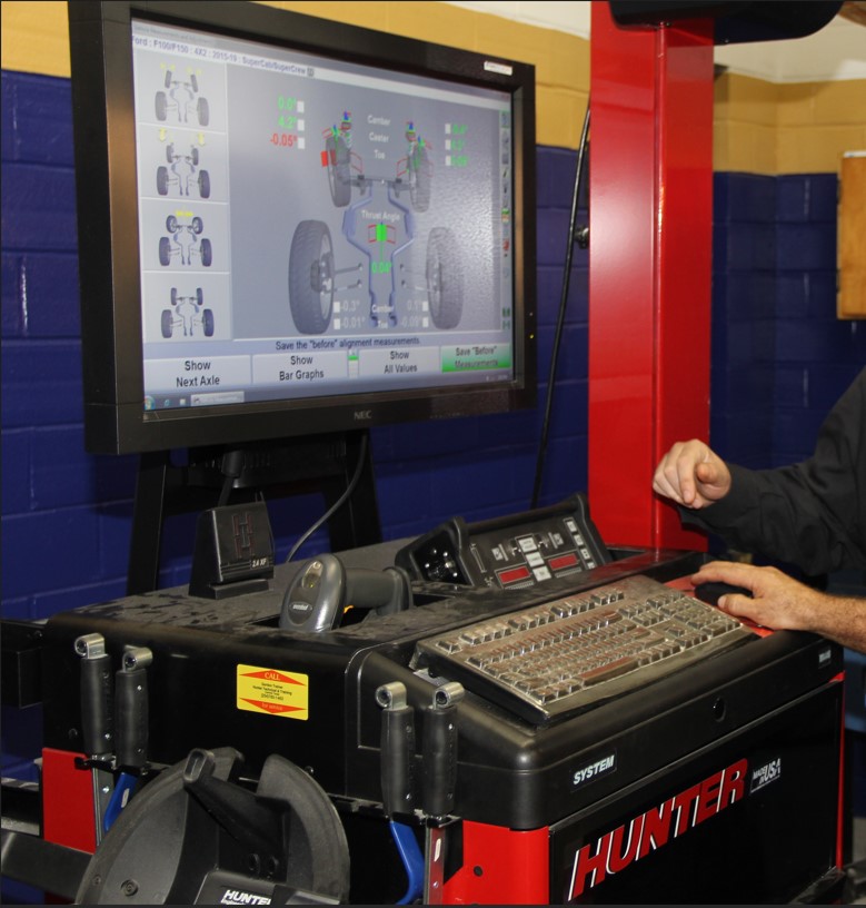Student using front end alignment machine