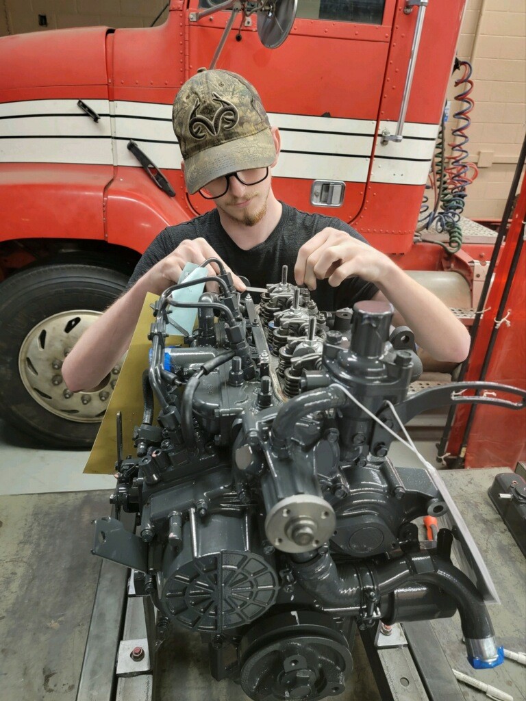 Student adjusting the engine valves on a Kubota engine