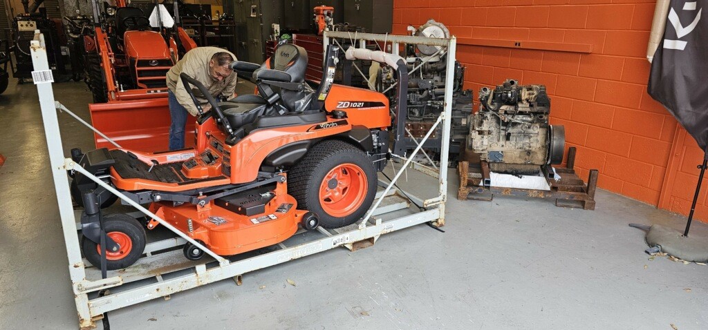 Student working on a Kubota zero turn tractor