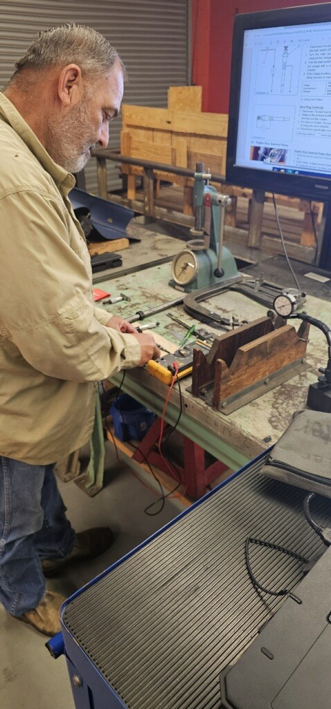 Student testing part with multimeter