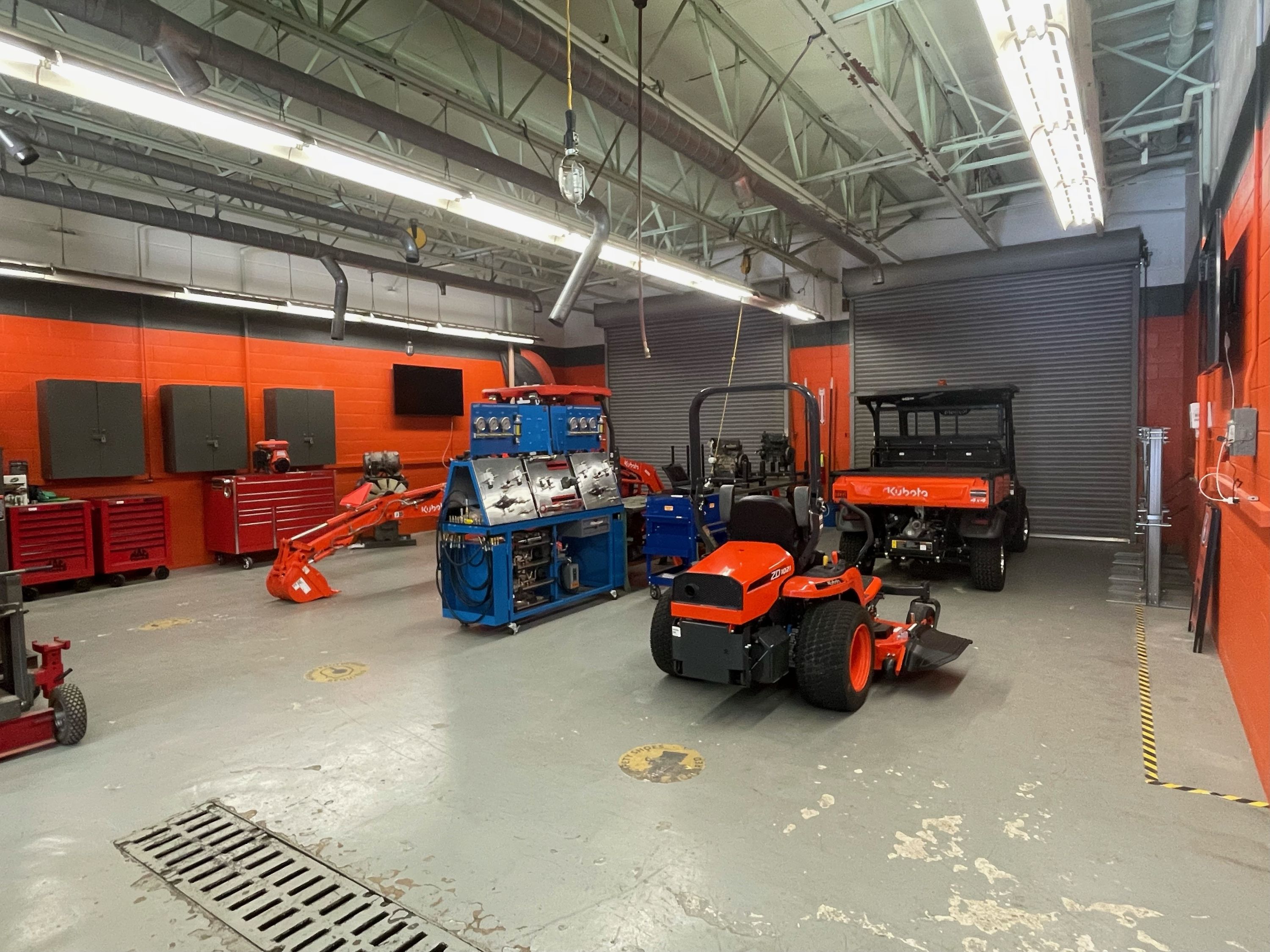 Kubota repair shop containing Kubota vehicles and engines