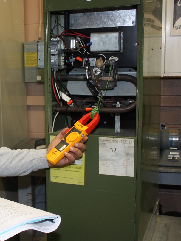 Student using multimeter to diagnose a problem