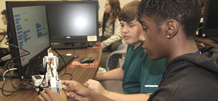 Continuing Education College for Kids students working with robotics
