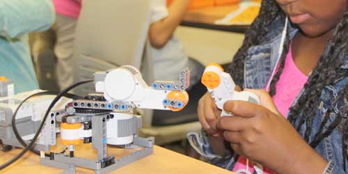 A female girl building a robot
