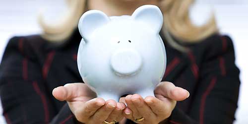 Hands holding a piggy bank
